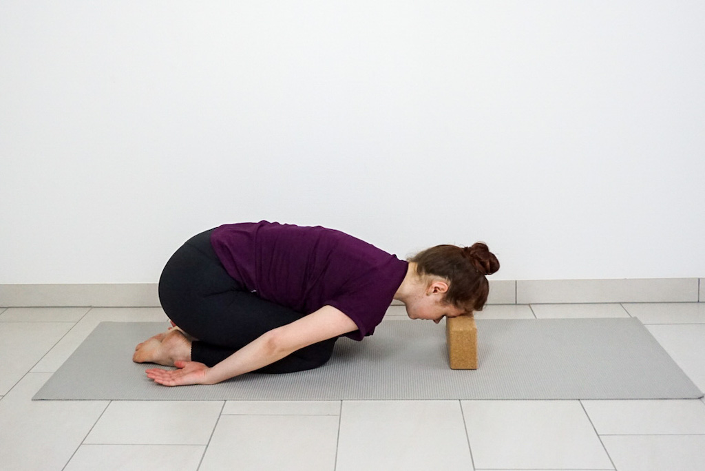 childs pose with yoga block