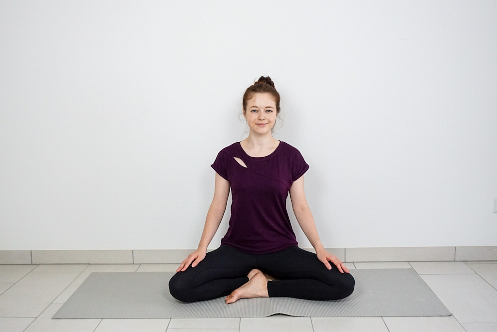 crossed leg yoga pose for beginners with yoga block