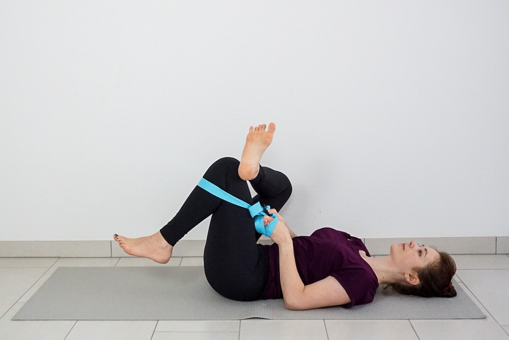 figure four glute stretch with yoga strap