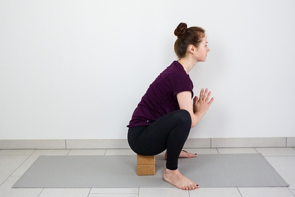 garland pose with yoga blocks