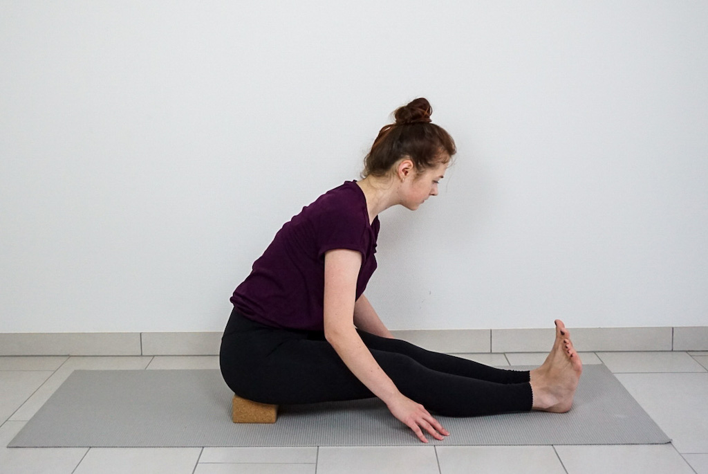 seated forward bend with yoga block