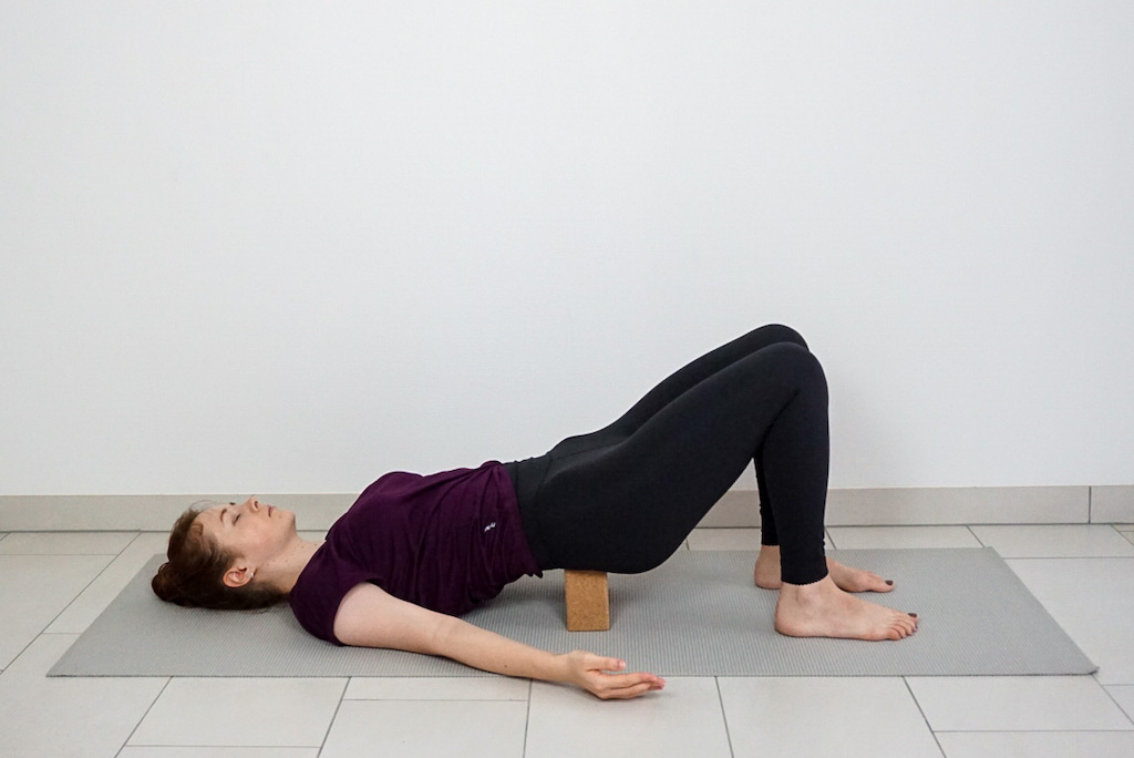 supported bridge pose with yoga block