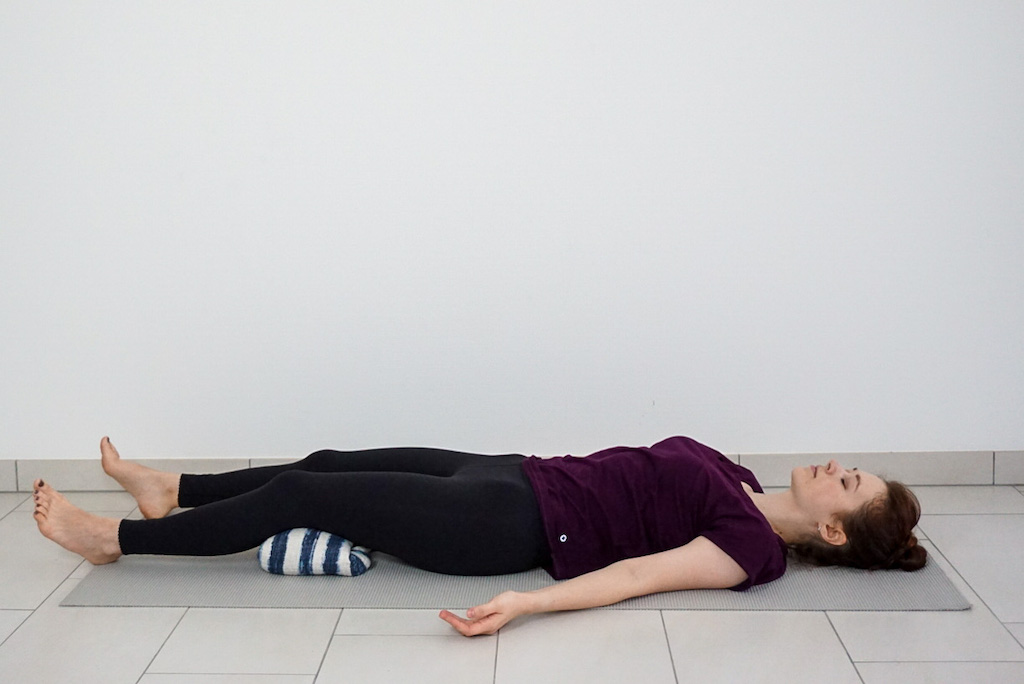 blanket under knees in savasana