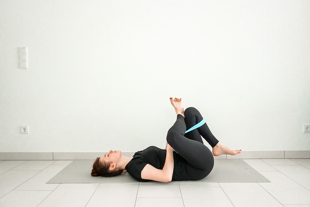 reclined pigeon pose with yoga strap yoga poses for tight hips