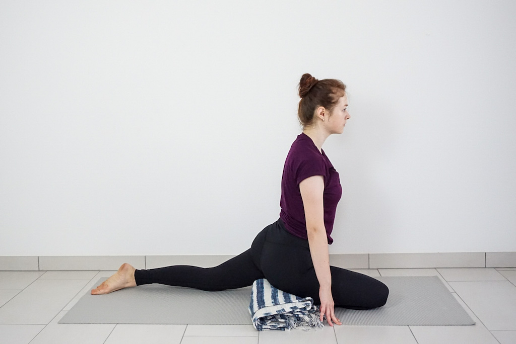 yoga blanket under hips in pigeon pose