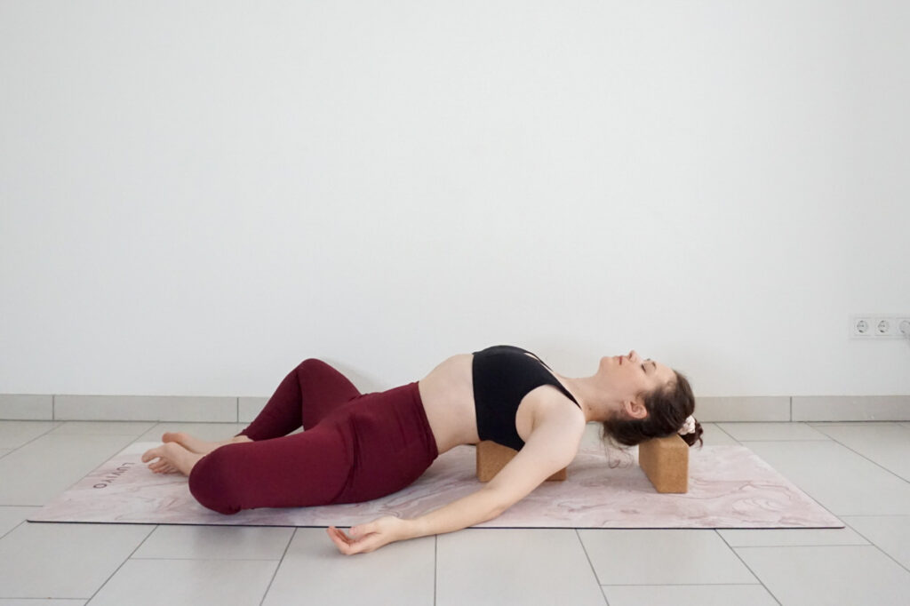 heart opening bound angle pose variation with yoga block on higher setting